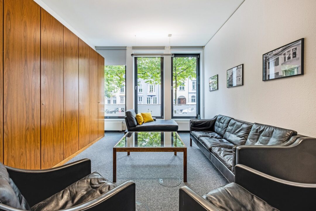 Empfangsbereich mit Ledersofas im Büro von Wolfgang Pauly Immobilien in Mönchengladbach